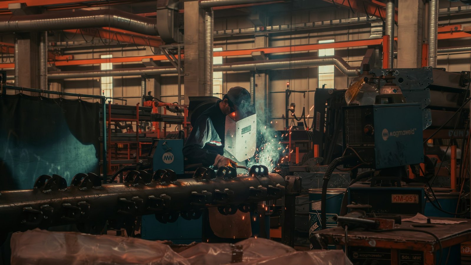 Soldador trabajando en línea de producción industrial